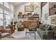 Bright living room featuring large windows, a built-in shelving unit, and comfortable seating at 8822 Fiesta Ter, Lone Tree, CO 80124