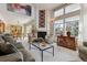 Bright and airy living room with a fireplace, large windows, and an open view to the dining area at 8822 Fiesta Ter, Lone Tree, CO 80124