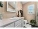 Bathroom with vanity, mirror, neutral walls, garden window, and dark tile floors at 6819 S Webster St # E, Littleton, CO 80128