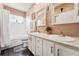Bright bathroom with double sinks, white cabinetry, and a bathtub/shower combo, offering functionality and style at 6819 S Webster St # E, Littleton, CO 80128