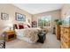 Relaxing bedroom with warm tones, comfortable bed, and ample storage, creating a peaceful sanctuary at 6819 S Webster St # E, Littleton, CO 80128
