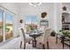 Bright dining room with natural light, seating for four, and a view of the balcony at 6819 S Webster St # E, Littleton, CO 80128