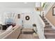 Welcoming entryway with a staircase, white door, and decorative accents at 6819 S Webster St # E, Littleton, CO 80128