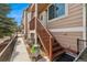 Charming townhouse exterior with a private front entrance, stairway, and landscaped garden at 6819 S Webster St # E, Littleton, CO 80128
