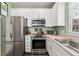 Well-equipped kitchen with stainless steel appliances and white cabinetry for a modern, clean look at 6819 S Webster St # E, Littleton, CO 80128