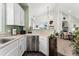 Open kitchen featuring stainless appliances and tile floor, transitioning into a connected dining and living space at 6819 S Webster St # E, Littleton, CO 80128