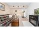 Cozy living room featuring a fireplace, plaid sofa, and wood-look flooring at 6819 S Webster St # E, Littleton, CO 80128