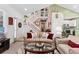 Bright living room with a staircase, sofa, glass table, and neutral color palette at 6819 S Webster St # E, Littleton, CO 80128