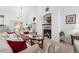 Comfortable living room featuring a fireplace, sofa, glass table, and lots of light at 6819 S Webster St # E, Littleton, CO 80128