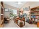 Well-lit home office with built-in bookcases, desk, and large windows at 6819 S Webster St # E, Littleton, CO 80128
