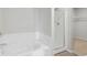 Bathroom featuring a soaking tub and a separate glass-enclosed shower at 7303 Dolores Ave, Frederick, CO 80530