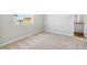 Bedroom with large window providing natural light and neutral carpet at 7303 Dolores Ave, Frederick, CO 80530