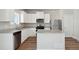Modern kitchen with white cabinets, stainless steel appliances, and granite countertops at 7303 Dolores Ave, Frederick, CO 80530