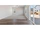 Spacious living room featuring a ceiling fan, a backyard view, and neutral paint at 7303 Dolores Ave, Frederick, CO 80530