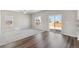 Bright living room features hardwood floors, a ceiling fan, and access to the backyard at 7303 Dolores Ave, Frederick, CO 80530