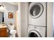 Well-lit bathroom includes a stackable washer and dryer at 3600 S Pierce St # 1-207, Denver, CO 80235