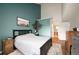 Bedroom featuring a decorative accent wall and ensuite bathroom entrance, providing convenience and style at 3600 S Pierce St # 1-207, Denver, CO 80235