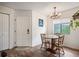 Dining room with modern lighting fixture, wood floors, and a window with lush green views at 3600 S Pierce St # 1-207, Denver, CO 80235