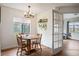 Cozy dining room area with wood table, chandelier lighting, and view of the exterior at 3600 S Pierce St # 1-207, Denver, CO 80235