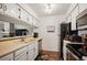 Cozy kitchen featuring white cabinets and stainless steel appliances at 3600 S Pierce St # 1-207, Denver, CO 80235