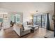 Bright and airy living room showcasing natural light and access to an outdoor patio space at 3600 S Pierce St # 1-207, Denver, CO 80235