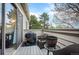 Outdoor patio with seating, a grill, and peaceful views of the surrounding trees at 3600 S Pierce St # 1-207, Denver, CO 80235