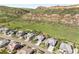 Aerial view showcases the neighborhood and the home's idyllic location near rolling hills at 4868 Hogback Ridge Rd, Morrison, CO 80465