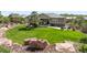 Large, well-maintained backyard featuring a patio, fire pit, and professional landscaping at 4868 Hogback Ridge Rd, Morrison, CO 80465