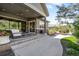 Spacious backyard with a covered patio, inviting seating area, and lush landscaping at 4868 Hogback Ridge Rd, Morrison, CO 80465