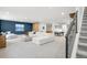 Open basement with a living area, ping pong table, and staircase to the upper floor at 4868 Hogback Ridge Rd, Morrison, CO 80465