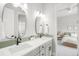 Well-lit bathroom with double sinks, sleek black faucets, and access to the bedroom at 4868 Hogback Ridge Rd, Morrison, CO 80465