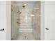 Stunning glass shower features gold fixtures and a unique chevron tile design at 4868 Hogback Ridge Rd, Morrison, CO 80465