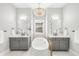 Elegant bathroom featuring dual sinks, a freestanding tub, and a stylish light fixture at 4868 Hogback Ridge Rd, Morrison, CO 80465
