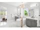 Bright bathroom featuring dual vanities, a luxurious tub, and a separate shower at 4868 Hogback Ridge Rd, Morrison, CO 80465