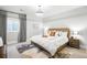 Bright bedroom with a wooden bed frame, geometric rug, and neutral decor at 4868 Hogback Ridge Rd, Morrison, CO 80465