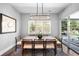 Bright dining room featuring a modern light fixture and a view of the serene outdoor landscape at 4868 Hogback Ridge Rd, Morrison, CO 80465