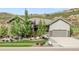 Beautiful single Gathering home boasts stone and siding details, landscaped front yard, and attached garage at 4868 Hogback Ridge Rd, Morrison, CO 80465