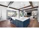 The kitchen features an island with seating, stainless appliances, and an open floor plan at 4868 Hogback Ridge Rd, Morrison, CO 80465