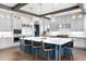 Kitchen features a large island with seating, stainless appliances, and stylish pendant lighting at 4868 Hogback Ridge Rd, Morrison, CO 80465