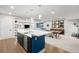 Modern kitchen island overlooks the living space, featuring sleek countertops and black cabinetry at 4868 Hogback Ridge Rd, Morrison, CO 80465