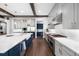 Kitchen features stainless steel appliances, hardwood floors, custom cabinets, and a large island at 4868 Hogback Ridge Rd, Morrison, CO 80465