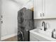 Laundry room with stackable washer/dryer and sleek fixtures at 4868 Hogback Ridge Rd, Morrison, CO 80465