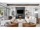 Open living room features a fireplace with a modern black tile surround and access to the backyard at 4868 Hogback Ridge Rd, Morrison, CO 80465