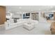 Bright living room features a large white sectional, modern decor, and open layout, perfect for entertaining at 4868 Hogback Ridge Rd, Morrison, CO 80465