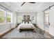 Tranquil main bedroom with tray ceiling, large windows, and an inviting decor at 4868 Hogback Ridge Rd, Morrison, CO 80465
