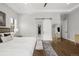 Spacious main bedroom with hardwood floors and barn-style door to walk-in closet at 4868 Hogback Ridge Rd, Morrison, CO 80465