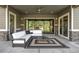 Covered patio features comfortable seating and a view of the lush outdoor landscape at 4868 Hogback Ridge Rd, Morrison, CO 80465