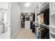 Bright walk-in closet with custom shelving, shoe racks and lots of hanging storage at 4868 Hogback Ridge Rd, Morrison, CO 80465