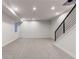 Finished basement with neutral carpet, recessed lighting, and an open staircase with metal railing at 8 S Colorado Blvd, Denver, CO 80246