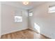 Well-lit bedroom with wood flooring and large windows offering natural light and pleasant street views at 8 S Colorado Blvd, Denver, CO 80246